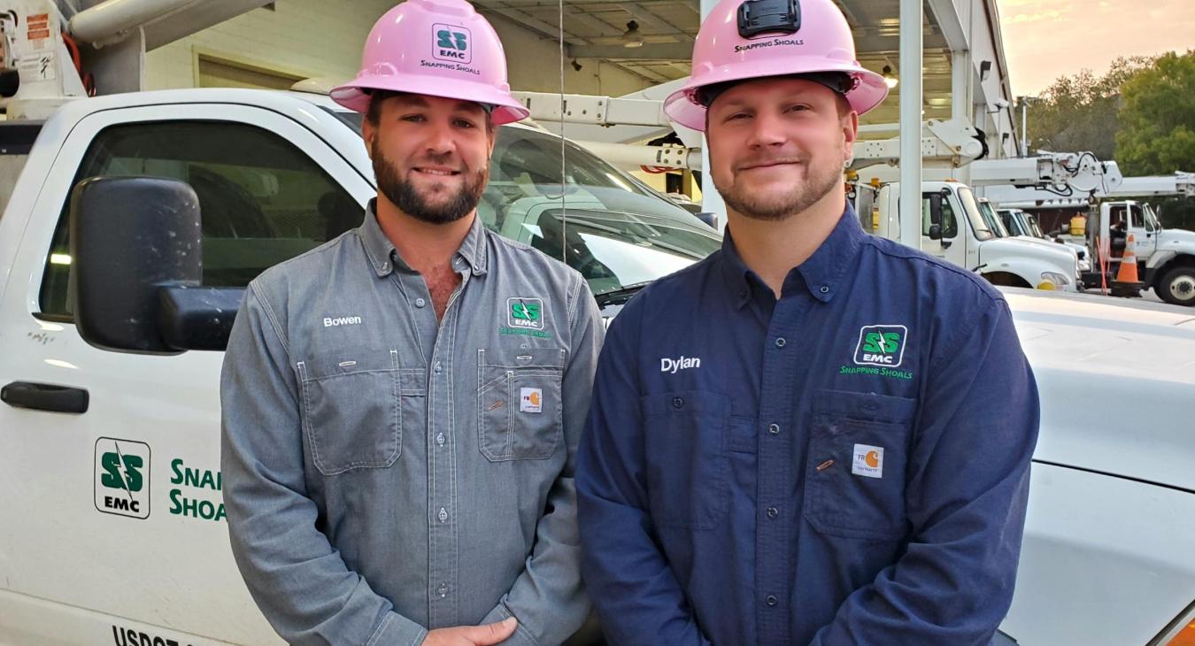 Linemen in pink hard hats